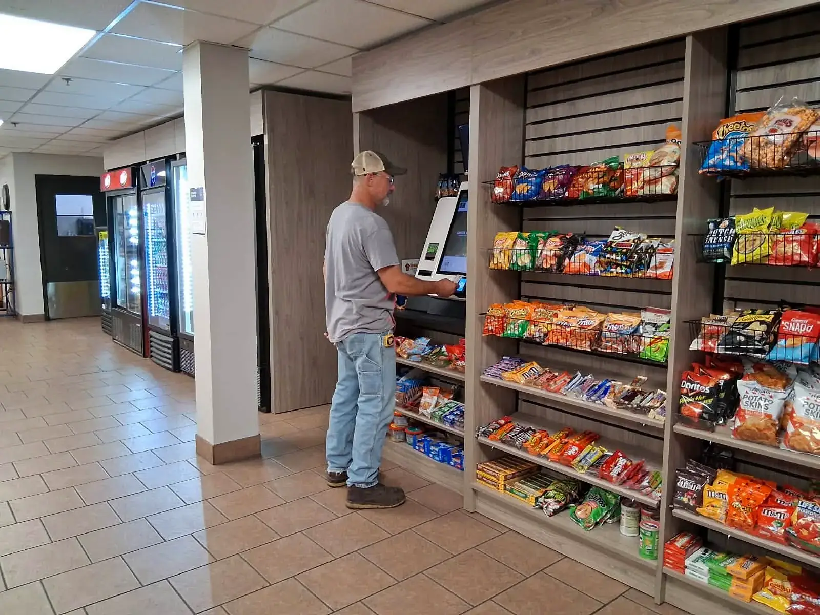 Customer checking out at a micro market kiosk