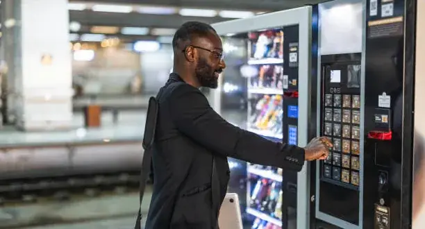 Employee buying from a snack vending machine